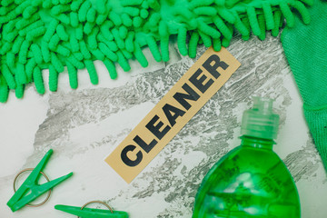 Ready for cleanup.Set of green cleaning tools: rags, brushes, dishwashing liquid on a light...