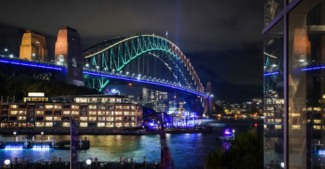 Naklejka na ściany i meble Sydney Harbour Bridge at night illuminated with green and purple lights