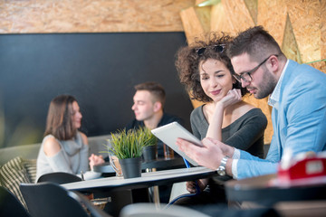 Couple discussing business at a coffee shop with hookah