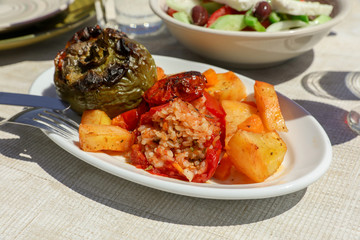 Rise stuffed fresh tomato and pepper in greek tavern.