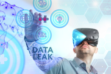 Business, Technology, Internet and network concept. Young businessman working in virtual reality glasses sees the inscription: Data leak