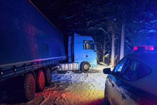 A Real Accident. Truck Traffic Accident At Night, On A Snowy Winter Road. Broken Truck On The Road In The Snow.