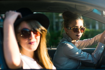 Two girl friends on a road trip by car