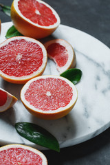 Close-up of grapefruits on the white marble tray.