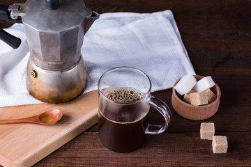 old coffee pot, geyser, glass mug with coffee, wooden background