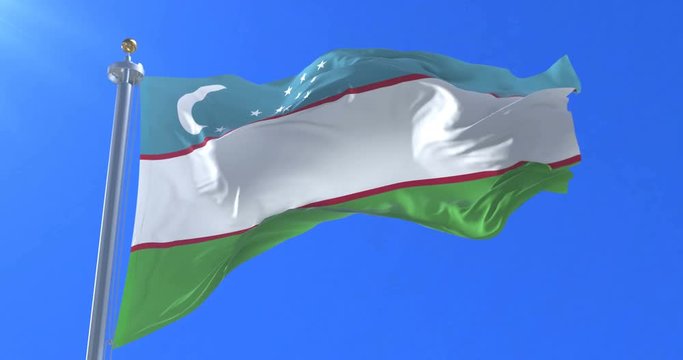 Flag of Uzbekistan waving at wind in slow with blue sky, loop