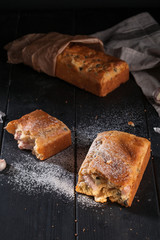 Homemade mini bread with fillers on dark wooden surface