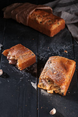 Homemade mini bread with fillers on dark wooden surface