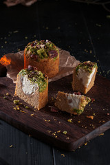 Homemade carrot cakes with pecans on dark wooden