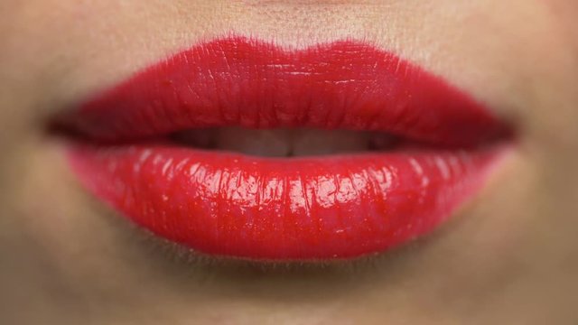 woman lips with red lipstick making kiss