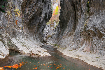 A large swirling chasm in the mountains at a gorge with a river flowing through it