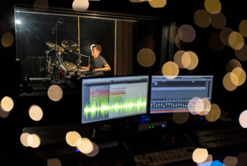 man playing drum kit at sound recording studio