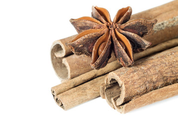 Star anise spice fruit on the cinnamon sticks closeup