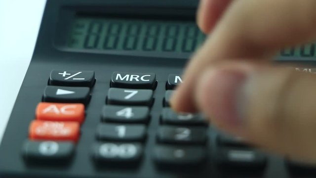 Counting on calculator. Finger presses the button calculator. Closeup.