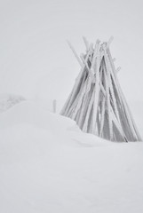 Wooden poles used for marking mountain trails in winter 