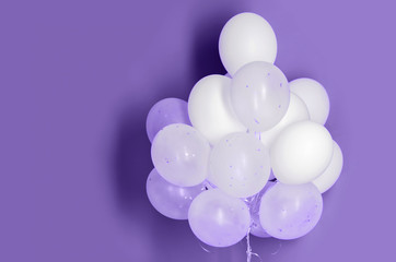 white helium balloons on ultra violet background
