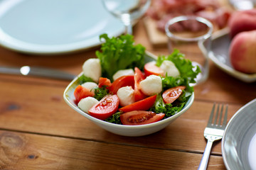 vegetable salad with mozzarella on wooden table