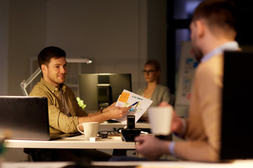 colleagues discussing project late in office