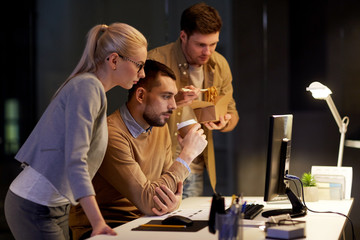 business team with computer working late at office