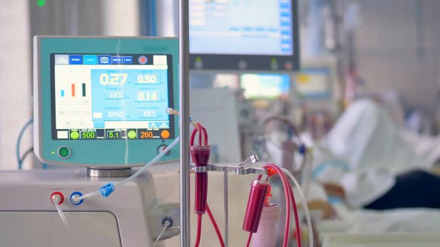 Medical screen displays patient's medical parameters: pulse, blood pressure, temperature.