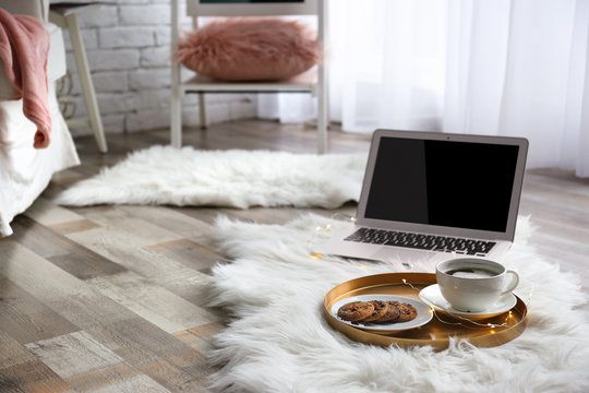 Tray With Breakfast And Laptop On Fluffy Carpet In Room