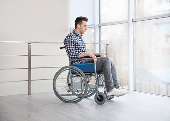 Young man in wheelchair indoors