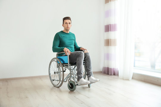 Young man in wheelchair indoors