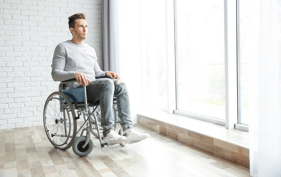 Young man in wheelchair indoors