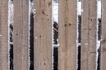wooden fence covered with hoarfrost