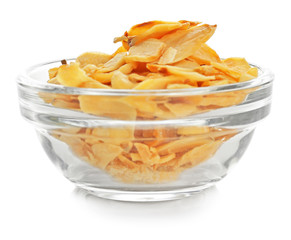 Dried garlic flakes in bowl on white background
