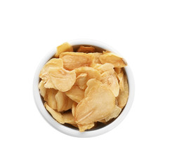 Dried garlic flakes in bowl on white background