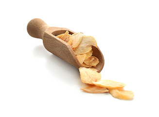 Dried garlic flakes in scoop on white background
