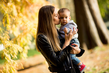 Fototapeta na wymiar Young mother and baby boy in autumn park