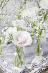 Floral arrangement with ranunculus flowers and white gypsophila paniculata.