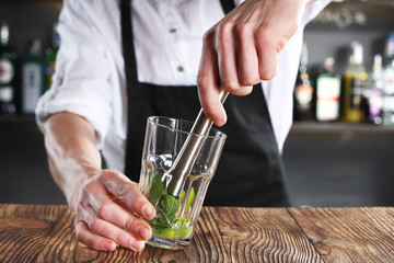 The bartender prepares a cocktail using the madler