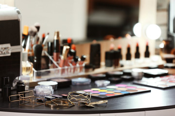Decorative cosmetics and tools on dressing table in makeup room