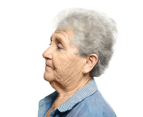 Elderly woman on white background. Hearing problem