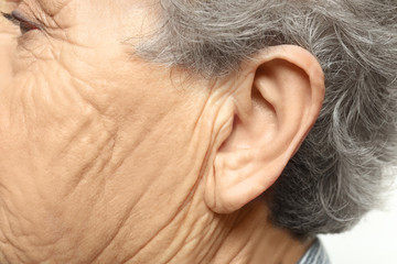 Fototapeta premium Elderly woman, closeup of ear. Hearing problem