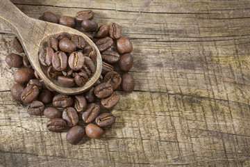 Obraz na płótnie Canvas Roasted coffee on the wooden background - Coffea
