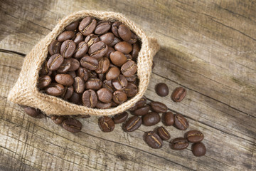 Roasted coffee on the wooden background - Coffea