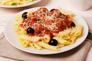 Penne pasta with meatballs in tomato sauce