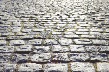 Cobbled street in early morning golden light.