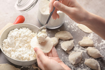 Woman making dumplings with cottage cheese, closeup