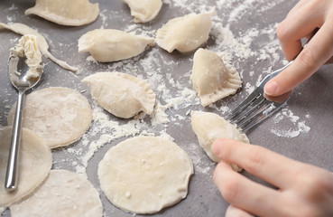 Woman making dumplings with cottage cheese, closeup