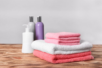 Fototapeta na wymiar Clean towels and toiletries on table