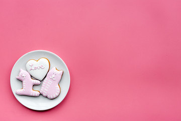 Valentine cookies. Hearts with lettering I love you, cat and puppy on pink background top view space for text