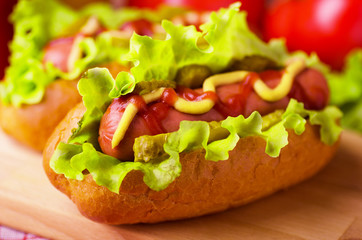 Hot dog with lettuce, mustard and ketchup