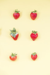 Fototapeta na wymiar Top view of colorful fruit pattern of fresh strawberries on yellow background