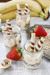 Layer dessert with muesli, chocolate and banana fruits.