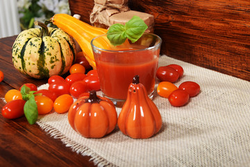 healthy tomato juice with basil made of sweet cocktail tomatoes and pumpkin and pumpkin salt containers with free space for text